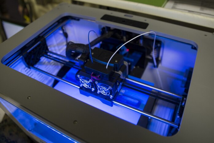 A 3-D printer belonging to Combat Logistics Battalion 31, 31st Marine Expeditionary Unit, prints tangible objects aboard the USS Wasp (LHD-1) while underway in the Pacific Ocean, March 22, 2018. Marines with CLB-31 are now capable of ~additive manufacturing,™ also known as 3-D printing, which is the technique of replicating digital 3-D models as tangible objects. The 31st MEU partners with the Navy™s Amphibious Squadron 11 to form the Wasp Amphibious Ready Group, a cohesive blue-green team capable of accomplishing a variety of missions across the Indo-Pacific.