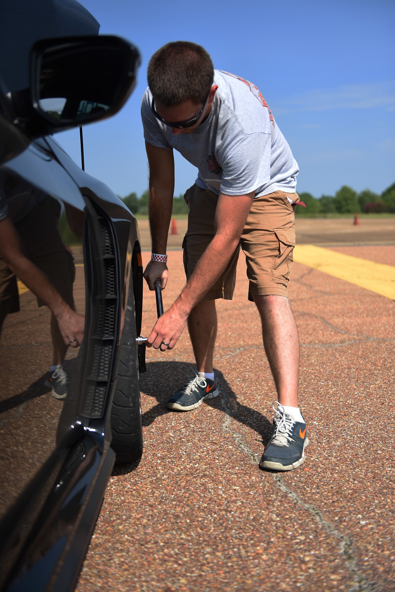 Sid Carter torques lug nuts during an autocross event Aug. 12, 2018, on Columbus Air Force Base, Mississippi. Carter drives a 2017 Honda Civic Type R that has been modified for racing. (U.S. Air Force photo by Airman 1st Class Beaux Hebert)