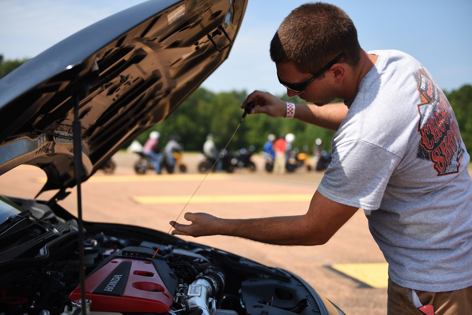Sid Carter checks the oil level on his car during an autocross event Aug. 12, 2018, on Columbus Air Force Base, Mississippi. Carter is a technical sergeant with the 172nd Aircraft Maintenance Squadron, Mississippi Air National Guard. (U.S. Air Force photo by Airman 1st Class Beaux Hebert)