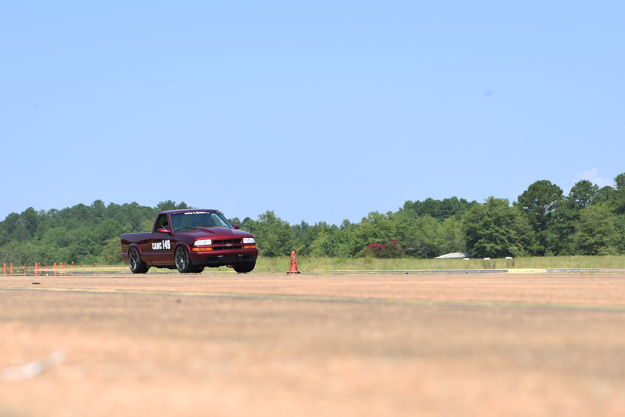 An autocross participant races on the SAC Ramp Aug. 12, 2018, on Columbus Air Force Base, Mississippi. Autocross is a base/community event where anyone can race their car on a set course here. (U.S. Air Force photo by Airman 1st Class Beaux Hebert)