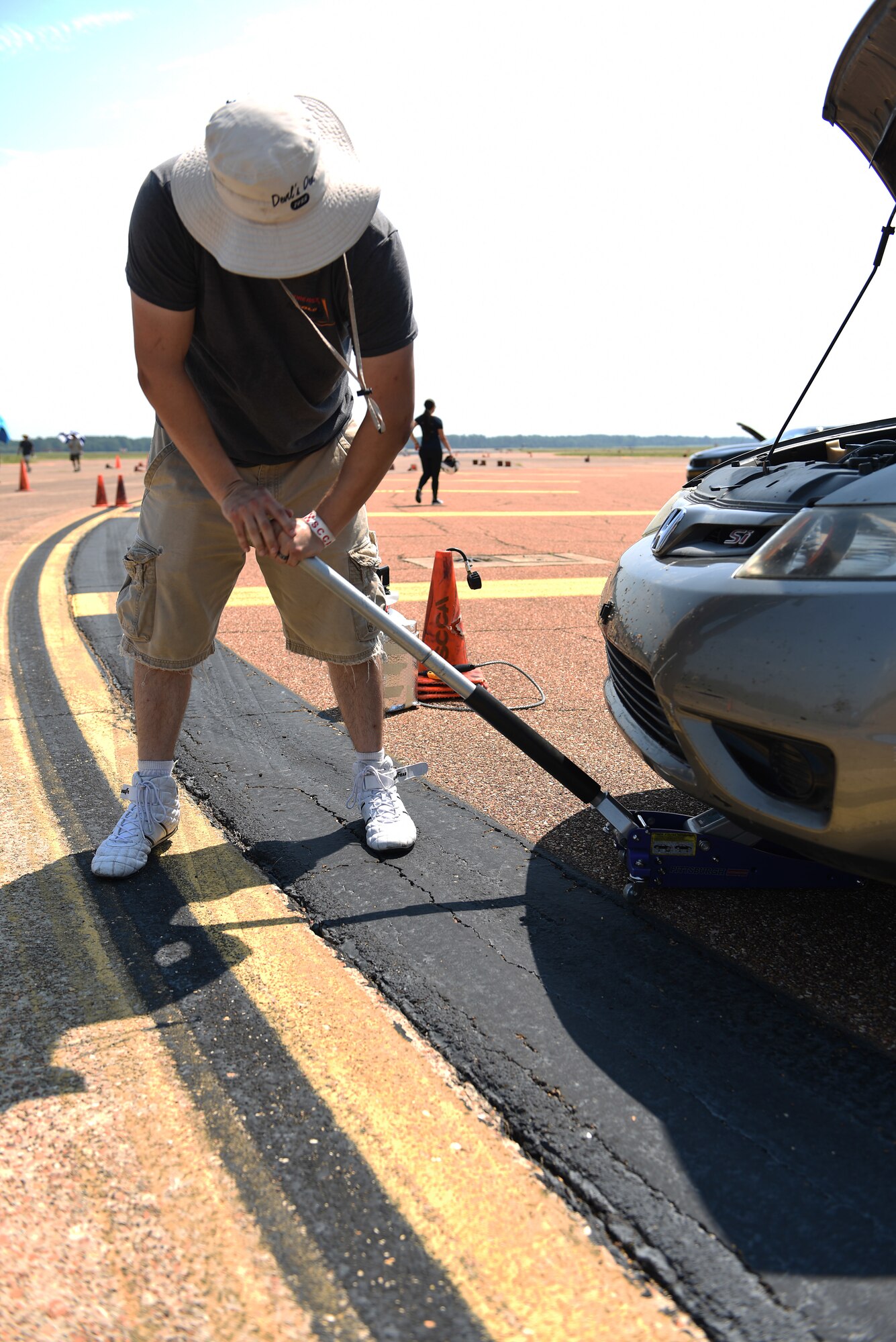Jeremy Mason uses a jack to lift his car during an autocross event Aug. 12, 2018, on Columbus Air Force Base, Mississippi. Mason has participated in these autocross events for eight years and is currently preparing for the Sports Car Club of America National Championship. (U.S. Air Force photo by Airman 1st Class Beaux Hebert)