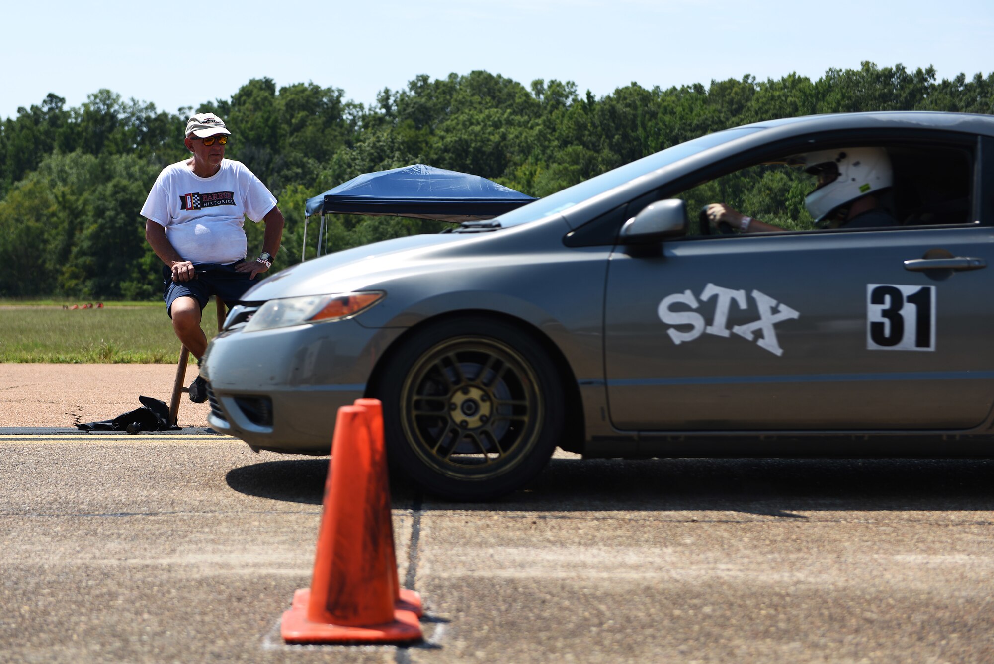 Chuck Bigelow, Columbus Air Force Base wingman, watches for infractions at the starting line during an autocross event Aug. 12, 2018, on Columbus AFB, Mississippi. Autocross is held on the SAC Ramp and is open to anyone with a valid driver’s license or at least 14 years old with a driver’s permit and accompanied by a licensed driver. (U.S. Air Force photo by Airman 1st Class Beaux Hebert)