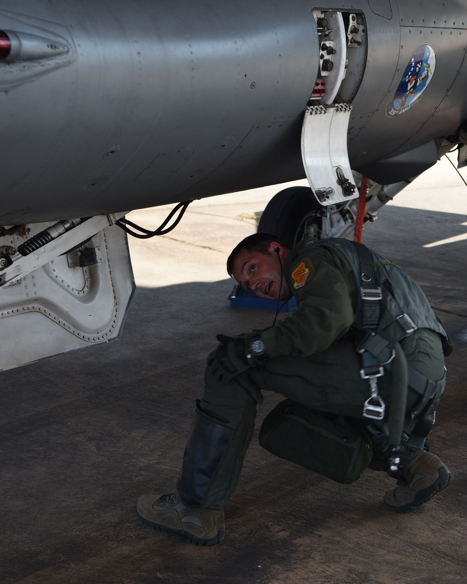 U.S. Air Force Capt. Ryan Neely, 309th Fighter Squadron flight commander, examines an F-16 Fighting Falcon prior to takeoff, Aug. 14, 2018 at Luke Air Force Base, Ariz.