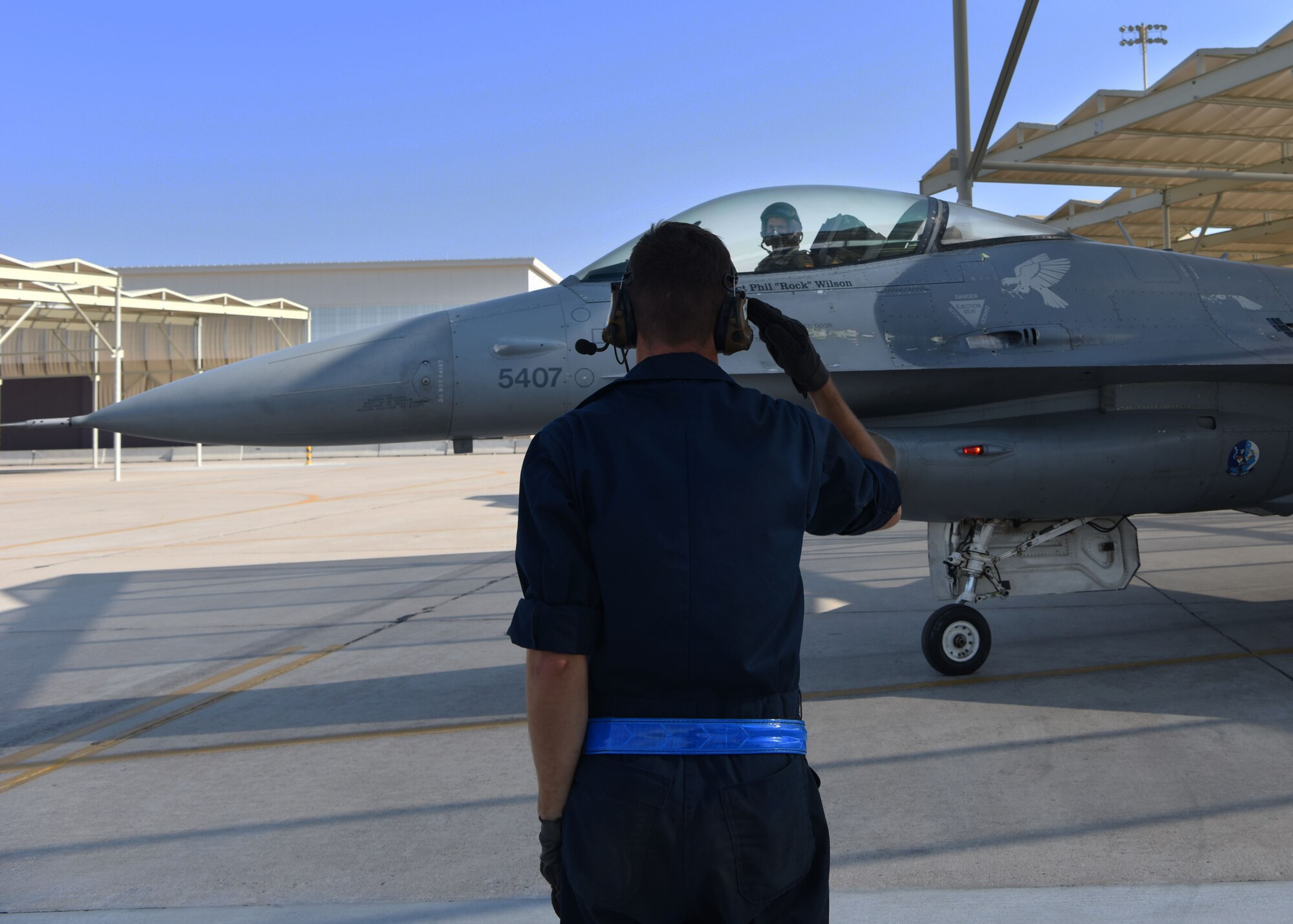 U.S. Air Force Airman Luke Prokop, 309th Aircraft Maintenance Unit crew chief, salutes Capt. Ryan Neely, 309th Fighter Squadron flight commander, as he taxis to the runway, August 14, 2018 at Luke Air Force Base, Ariz.