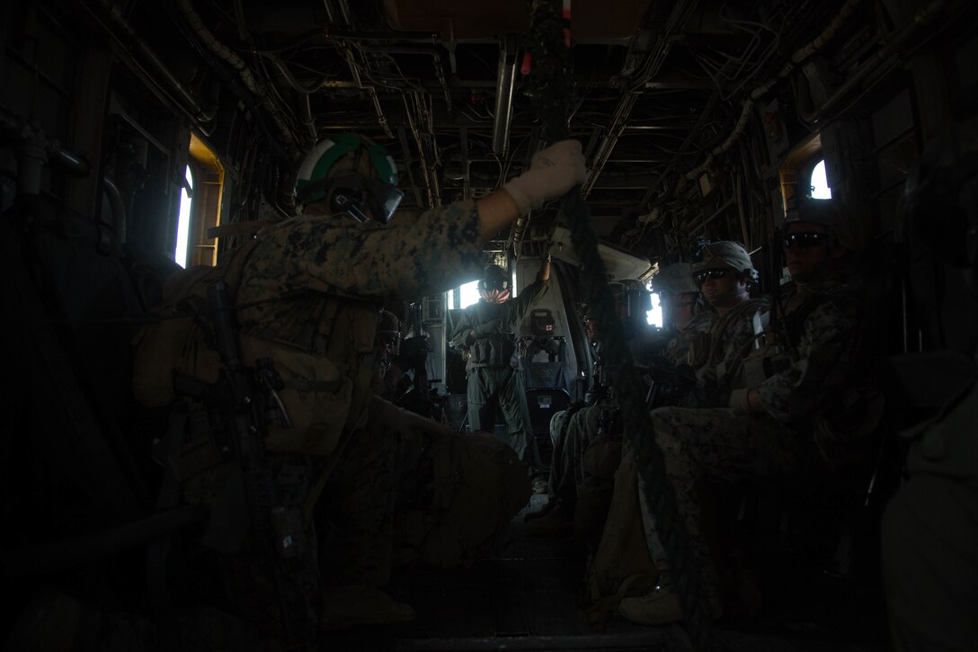 Sgt. Xavier Rodriguez, a crew chief with Marine Heavy Helicopter Squadron (HMH) 465, Marine Aircraft Group 16, 3rd Marine Aircraft Wing, ensures the safety of Marines during flight during fast-roping exercises over Marine Corps Base Camp Pendleton, Calif., Aug. 10. HMH-465 conducts training with Amphibious Raids Branch, Expeditionary Operations Training Group, I Marine Expeditionary Force, to assist infantry Marines performing fast-rope training from a helicopter. (U.S. Marine Corps photo by Cpl. Ariana Acosta)