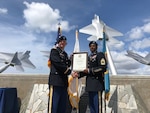 Army Col. Rick Ellis, 8th Theater Sustainment Command deputy commander, present Army Master Sgt. Larry Hogan the certificate of retirement during a ceremony Aug. 14 at Joint Base Pearl Harbor Hickam Missing Man Formation.  Photo by Dr. John Hamilton