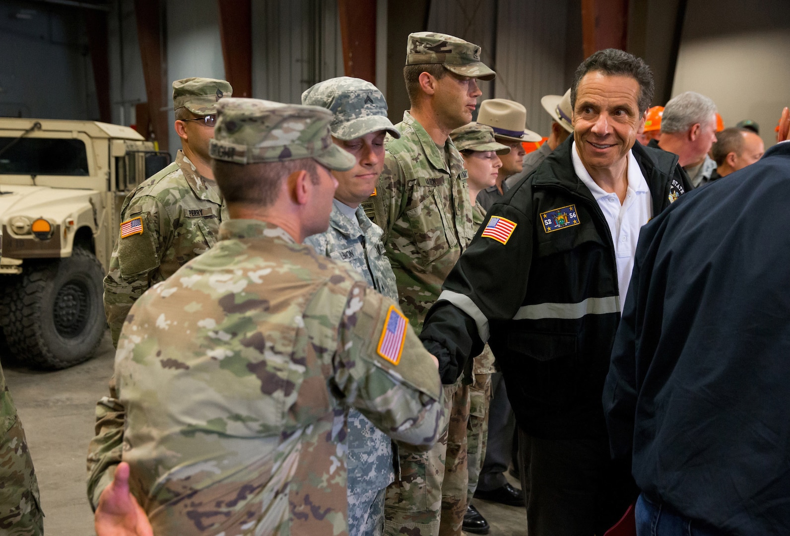 New York Gov. Andrew M. Cuomo greets members of the new York Army National Guard's 204th Engineer Battalion who were on duty to respond to heavy flooding the in New York's Finger Lakes and Southern Tier regions on Tuesday, August 14,2018 in Vestal, N.Y. The governor declared a disaster area in 14 counties and mobilized 200 New York National Guard Airmen and Soldiers as part of the state response.