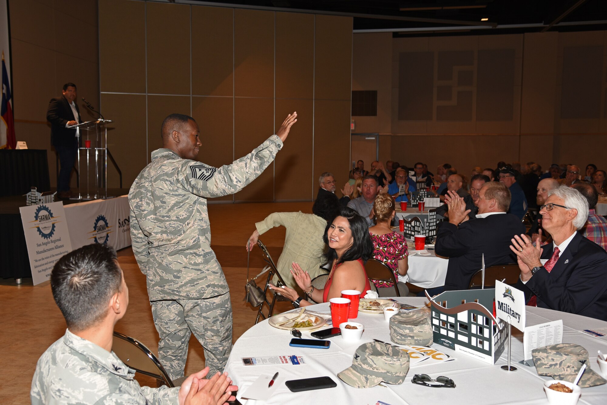 U.S. Air Force Chief Master Sgt. Lavor Kirkpatrick, 17th Training Wing command chief, greets attendees at the San Angelo Chamber of Commerce luncheon at the McNease Convention Center in San Angelo, Texas, Aug. 14, 2018. Kirkpatrick and Col. Robert Ramirez, 17th TRW vice commander, attended the event to introduce themselves to community members. (U.S. Air Force photo by Staff Sgt. Joshua Edwards/Released)