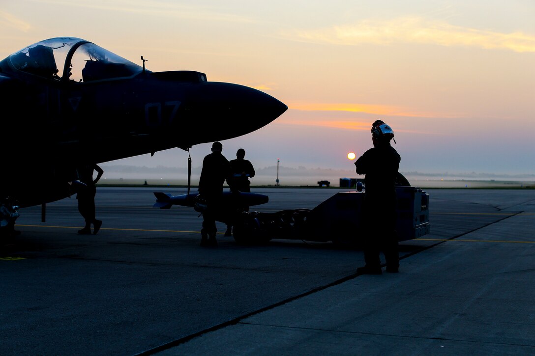 Marines with Marine Attack Squadron (VMA) 311 prepare ordnance on an AV-8B Harrier II during Exercise Northern Lightning at Volk Field Counterland Training Center, Camp Douglas, Wis. Aug. 14. Exercise Northern Lightning 2018 allows the Air Force, Marine Corps and Navy to strengthen interoperability between services and gives the different branches a greater understanding of aviation capabilities within a joint fighting force. (U.S. Marine Corps photo by Sgt. David Bickel)