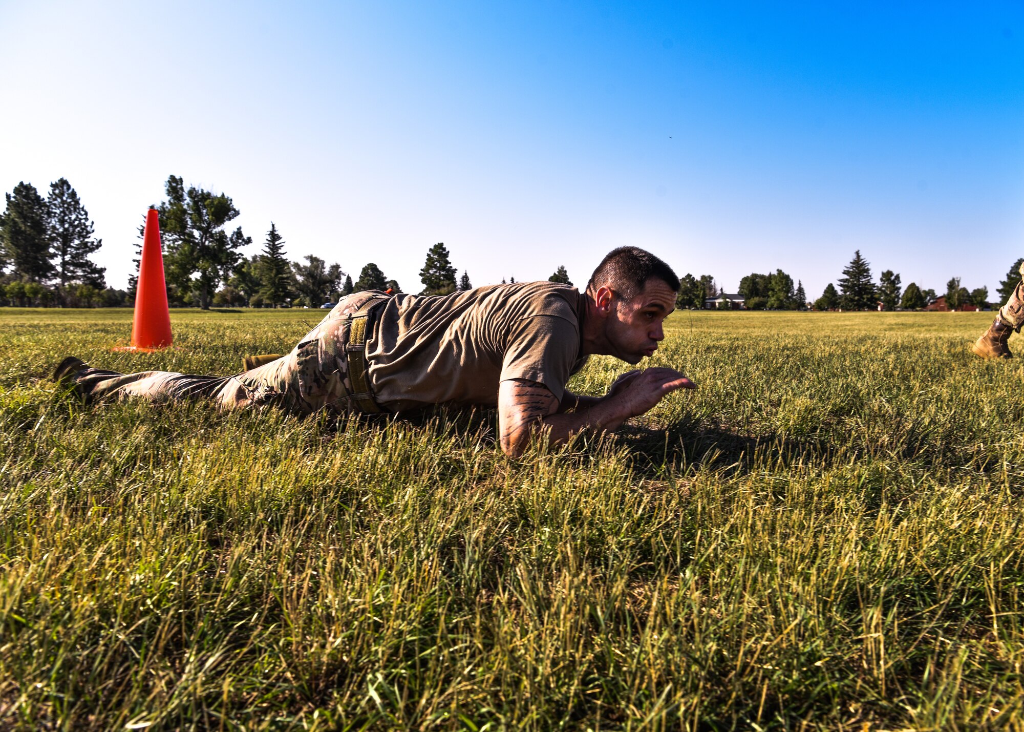 Maj. David Lycan, 890th Missile Security Forces Squadron commander, performs a low crawl as part of the U.S. Marine Corps Combat Fitness Test Aug. 9, 2018 on F.E. Warren Air Forces Base, Wyo. While the Marines have to complete this test along with their annual physical fitness test, the Air Force doesn’t have a test in place to simulate battlefield scenarios, taking on the Marine CFT gives Airmen the opportunity to demonstrate their capabilities. (U.S. Air Force photo by Airman 1st Class Braydon Williams)