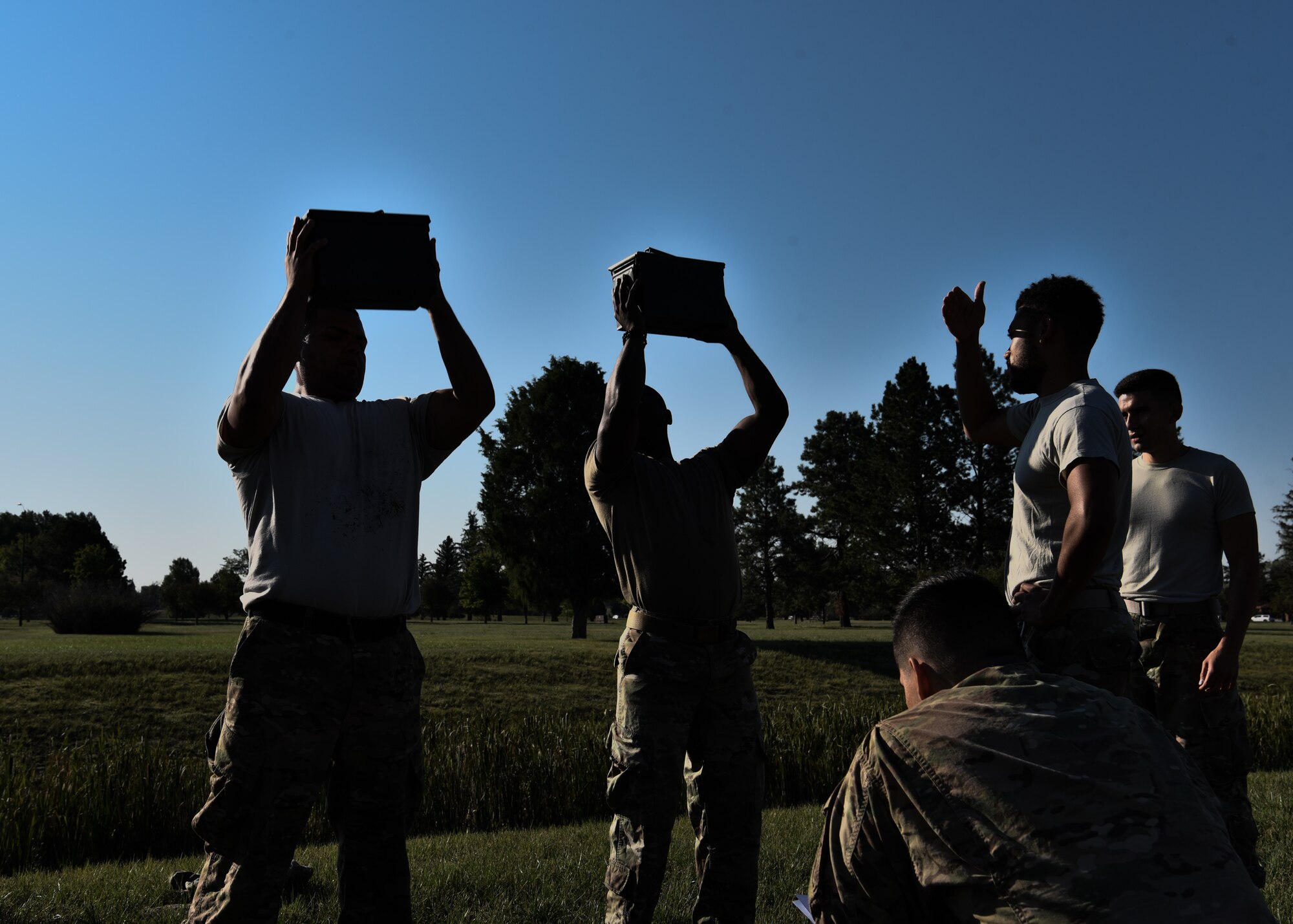 Airman from the 890th Missile Security Forces Squadron lift a 30 pound ammo can above their head as many times as possible in two minutes as part of the U.S. Marine Corps Combat Fitness Test Aug. 9, 2018 on F.E. Warren Air Force Base, Wyo. The CFT is a test designed to simulate combat scenarios while also testing the capabilities of the U.S. military’s front line war fighters. (U.S. Air Force photo by Airman 1st Class Braydon Williams)