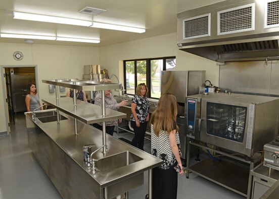 Parents get a tour of the new kitchen installed in the School Age Annex Aug. 15. The annex was reopened after a seven-month renovation project. (U.S. Air Force photo by Kenji Thuloweit)