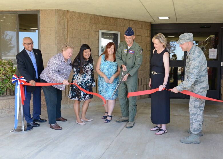 From left to right: Murray Westley, 412th Civil Engineer Squadron director; Gwyneth Bown, 412th Force Support Squadron Child and Youth Programs Flight chief; Colleen Evangelista-Weeks, 412th FSS; Kristen Burks, 412th FSS; Brig. Gen. E. John Teichert; 412th Test Wing commander; Janice Hollen, 412th FSS director; and Col. Jeffry Hollman, 412th Mission Support Group commander; cut the ceremonial red ribbon to officially reopen the School Age Annex Aug. 15. (U.S. Air Force photo by Kenji Thuloweit)