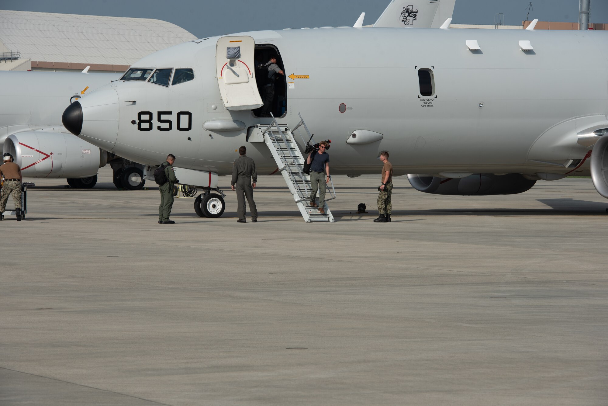 CNN Reporter Ivan Watson walks down the stairs of a U.S. Navy P-8A Poseidon after a flight Aug. 10, 2018, at Kadena Air Base, Japan. News agencies were invited to fly on the P-8A to learn about the Poseidon’s abilities and the role it plays in the Pacific region. (U.S. Air Force photo by Staff Sgt. Micaiah Anthony)
