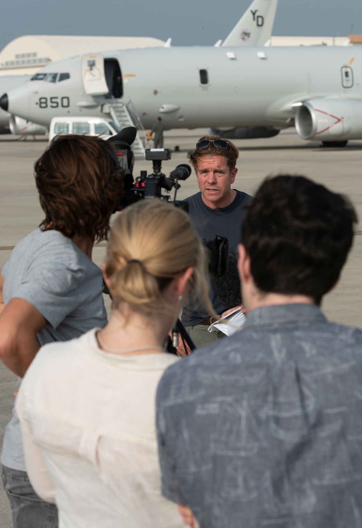 CNN Reporter Ivan Watson airs a live report after a flight on a U.S. Navy P-8A Poseidon Aug. 10, 2018, at Kadena Air Base, Japan. News agencies were invited to fly on the P-8A to learn about the Poseidon’s abilities and the role it plays in the Pacific region. (U.S. Air Force photo by Staff Sgt. Micaiah Anthony)