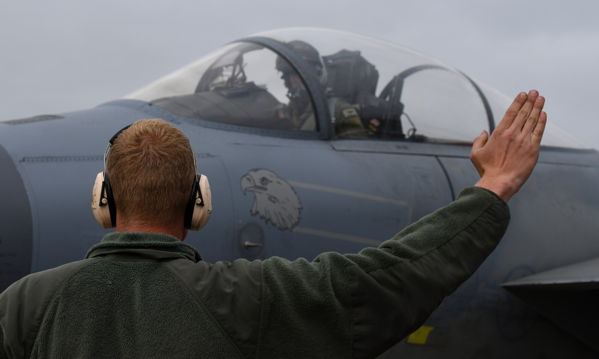 An Airman assigned to the 748th Aircraft Maintenance Squadron marshals an F-15C Eagle for departure at Keflavik Air Base, Iceland, Aug. 2, 2018, in support of NATO’s Icelandic Air Surveillance mission. During IAS, the 748th AMXS Airmen are responsible for maintaining the four mission critical F-15s as well as 10 additional jets designated for training. (U.S. Air Force photo/Staff Sgt. Alex Fox Echols III) (U.S. Air Force photo/Staff Sgt. Alex Fox Echols III)