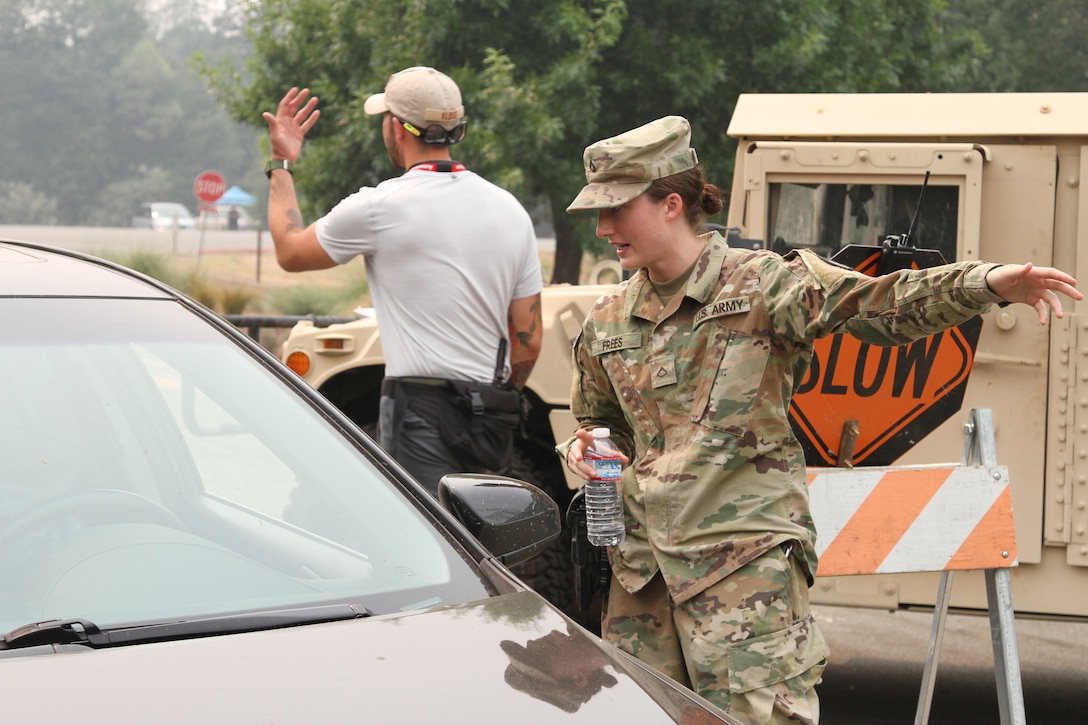 National Guard soldier talks with a motorist.