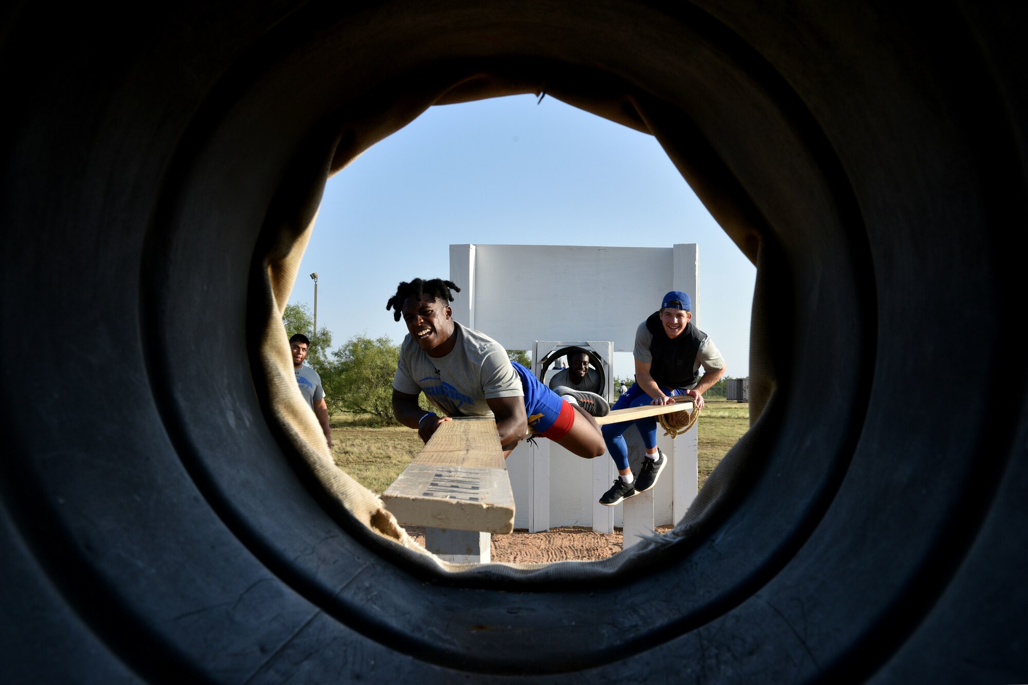 Angelo State University Student, Bam Howard, positions a plank on the Libby’s Culvert obstacle on Goodfellow Air Force Base, Texas, Aug. 15, 2018. The team had to deliver a heavy ammo can over difficult terrain using limited resources within 30 minutes. (U.S. Air Force photo by Senior Airman Randall Moose/Released)