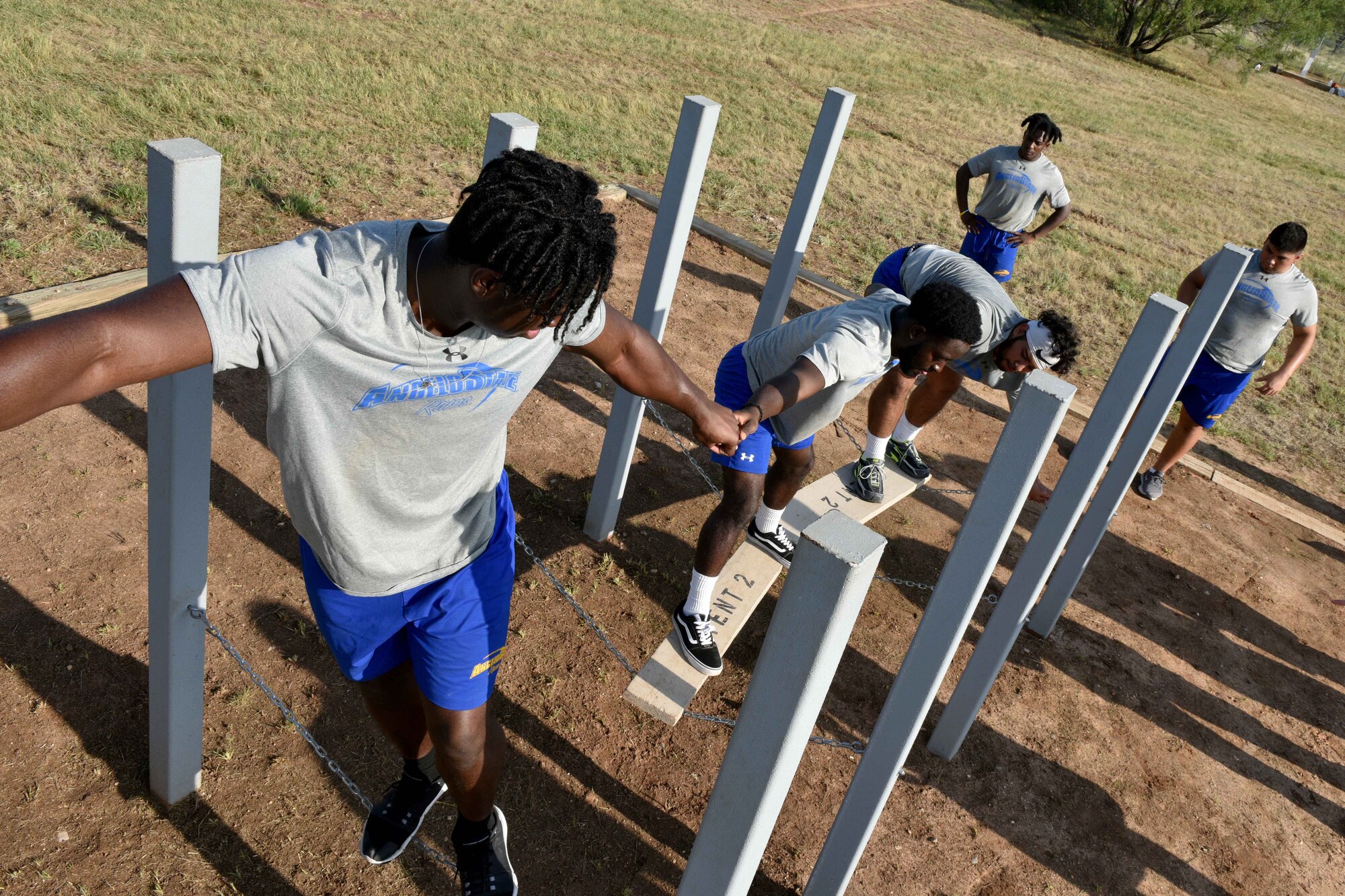 Angelo State University students help each other over a chain bridge on Specker’s Ascension obstacle on Goodfellow Air Force Base, Texas, Aug. 15, 2018. The 344th Military Intelligence Battalion dedicated the six obstacles to soldiers who earned the Medal of Honor. (U.S. Air Force photo by Senior Airman Randall Moose/Released)