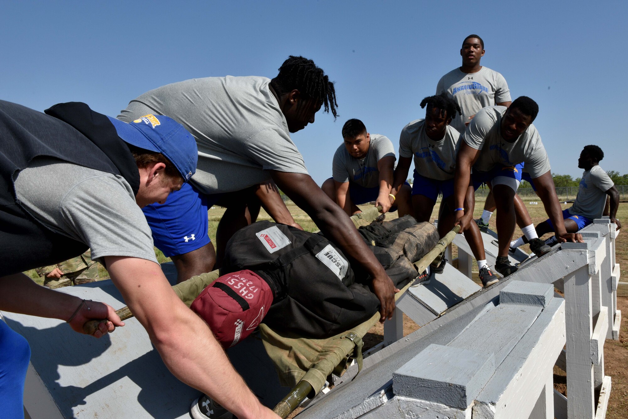 Angelo State University students carry a 200-pound litter on the Miller’s Crossing obstacle on Goodfellow Air Force Base, Texas, Aug. 15, 2018. The team had to carry the weighted litter over difficult terrain using limited resources within 10 minutes. (U.S. Air Force photo by Senior Airman Randall Moose/Released)