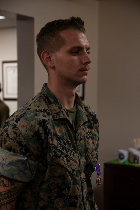 Lance Cpl. Dillon Bennett, machine gunner, 3rd Battalion, 7th Marine Regiment, receives a Purple Heart from Col. Kyle B. Ellison, commanding officer, 7th Marine Regiment, at 7th Marines’ Headquarters aboard the Marine Corps Air Ground Combat Center, Twentynine Palms, Calif., July 27, 2018. Bennett received the Purple Heart for wounds sustained while deployed to his area of operations on July 9, 2018. (Marine Corps photo by Lance Cpl. Dave Flores)