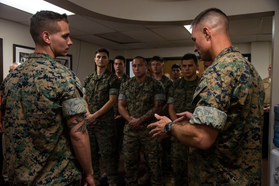Col. Kyle B. Ellison, commanding officer, 7th Marine Regiment, speaks about the actions and the esprit de corps that Lance Cpl. Dillon Bennett, machine gunner, 3rd Battalion, 7th Regiment, displayed following the presentation of a Purple Heart to Bennett at 7th Marines’ Headquarters aboard the Marine Corps Air Ground Combat Center, Twentynine Palms, Calif., July 27, 2018. Bennett received the Purple Heart for wounds sustained while deployed to his area of operations on July 9, 2018. (Marine Corps photo by Lance Cpl. Dave Flores)