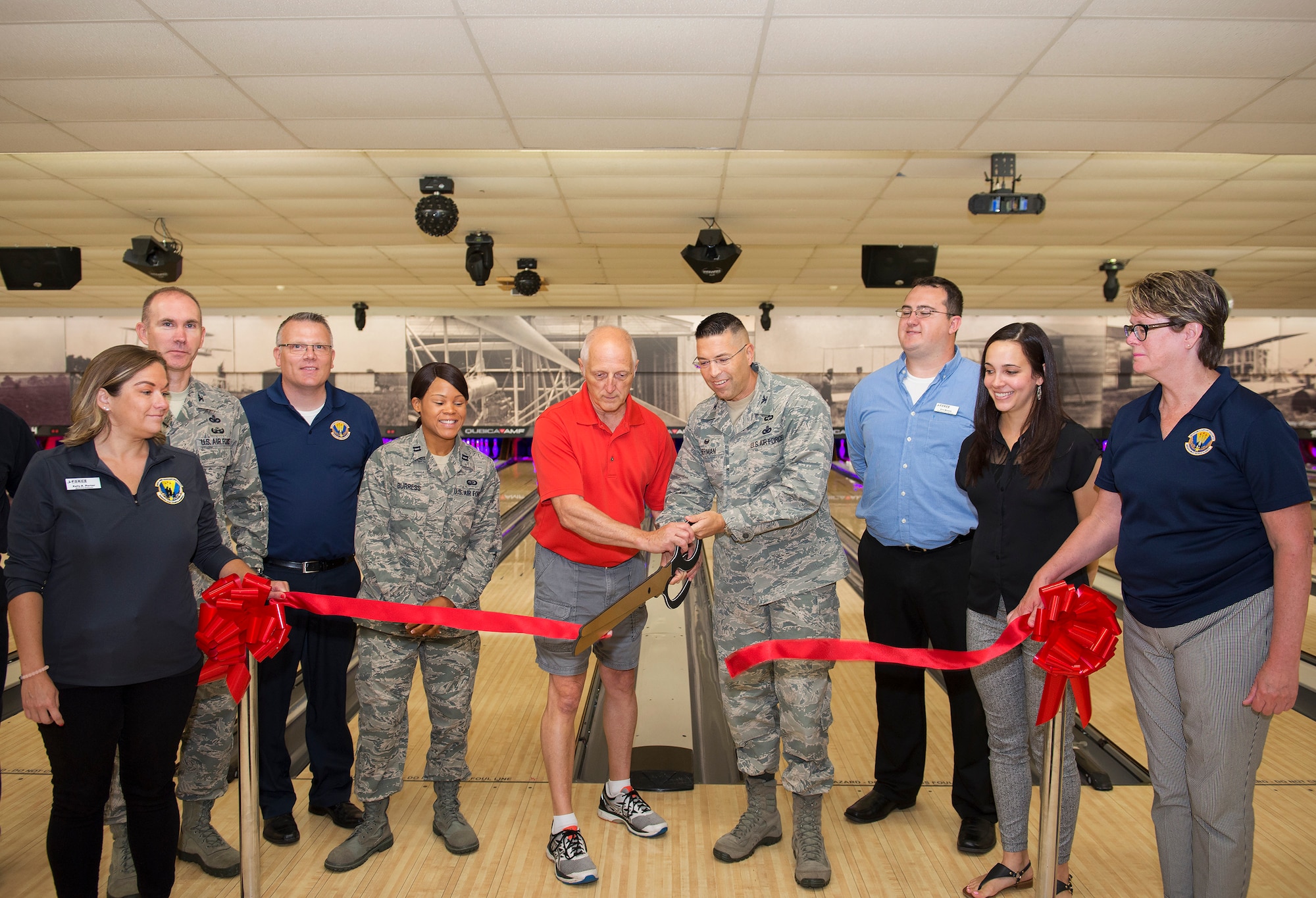 Col. Thomas P. Sherman, 88th Air Base Wing commander, and Mike Hellmann, Wednesday After Thoughts Bowling League secretary cut the ceremonial ribbon for the Wright-Patterson Air Force Base, Ohio, Bowling Center Aug. 13, 2018.