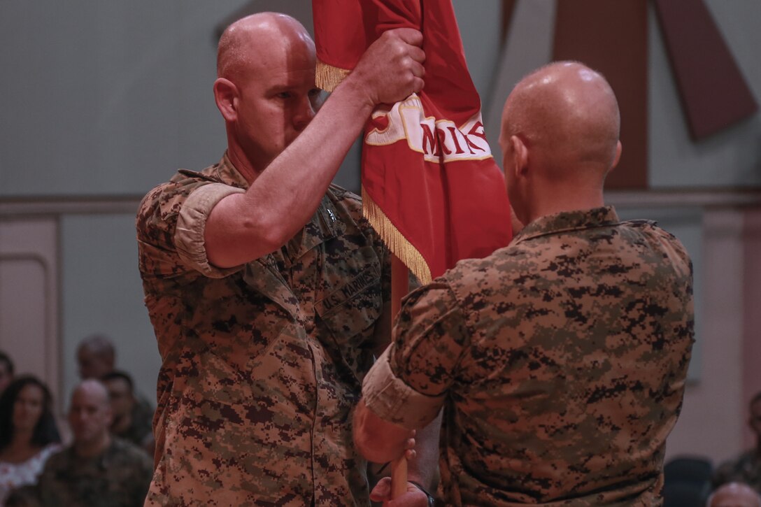 Master Gunnery Sgt. Keith Bonnell, senior enlisted advisor, Marine Corps Tactics and Operations Group, takes control of the unit colors during the 10-year anniversary ceremony of MCTOG aboard the Marine Corps Air Ground Combat Center, Twentynine Palms, Calif., Aug. 10th, 2018. MCTOG celebrated its 10th anniversary and conducted a change of command ceremony during which Col. Timothy Barrick relinquished command of MCTOG to Col. Gregory Poland. (U.S. Marine Corps photo by Lance Cpl. Preston L. Morris)