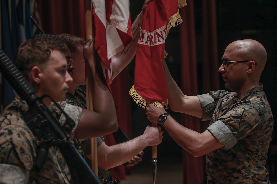 Col. Gregory Poland, left, receives the unit colors for Marine Corps Tactics and Operations Group from Col. Timothy Barrick, signifying the change of command for the unit during the 10th anniversary ceremony of MCTOG aboard the Marine Corps Air Ground Combat Center, Twentynine Palms, Calif., Aug. 10th, 2018. MCTOG celebrated its 10th anniversary and conducted a change of command ceremony during which Barrick relinquished command of MCTOG to Poland. (U.S. Marine Corps photo by Lance Cpl. Preston L. Morris)