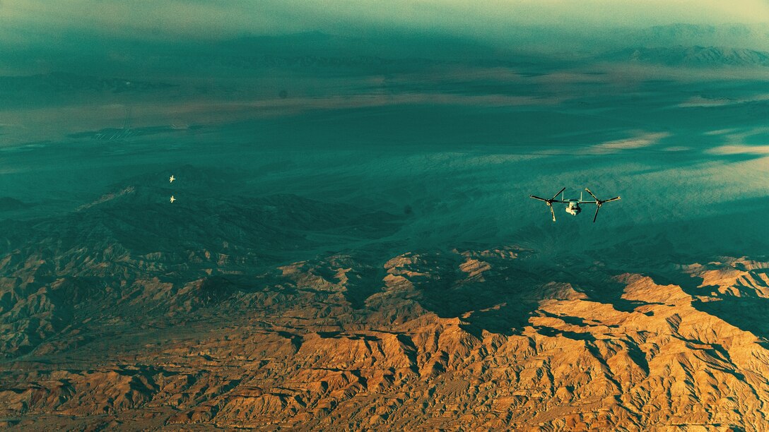 Two hornets and an Osprey with Marine Medium Tilt Rotor Squadron fly over Marine Corps Air Ground Combat Center, Twentynine Palms, Calif., as a part of an aerial flight formation exercise August 12, 2018. “I get to see the world from the sky,” said Sgt. Derek Levi, MV22 crew chief, Marine Medium Tilt Rotor Squadron, Marine Aircraft Group 16, 3rd Marine Aircraft Wing, “While I work on the ground, I get to work on the aircraft while watching young Marines become experts in their field and leaders of others.” The exercise was completed as a form of demonstration of the capabilities of the VMM-165. (U.S. Marine Corps photo by Lance Cpl. Rachel K. Young)