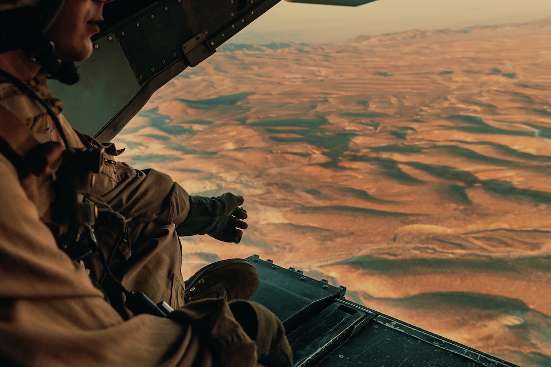 Sgt. Derek Levi, MV22 crew chief, Marine Medium Tilt Rotor Squadron, Marine Aircraft Group 16, 3rd Marine Aircraft Wing looks over the landscape of Marine Corps Air Ground Combat Center, Twentynine Palms, Calif., during an aerial flight formation exercise August 12, 2018.  The exercise was completed as a form of demonstration of the capabilities of the VMM-165. (U.S. Marine Corps photo by Lance Cpl. Rachel K. Young)