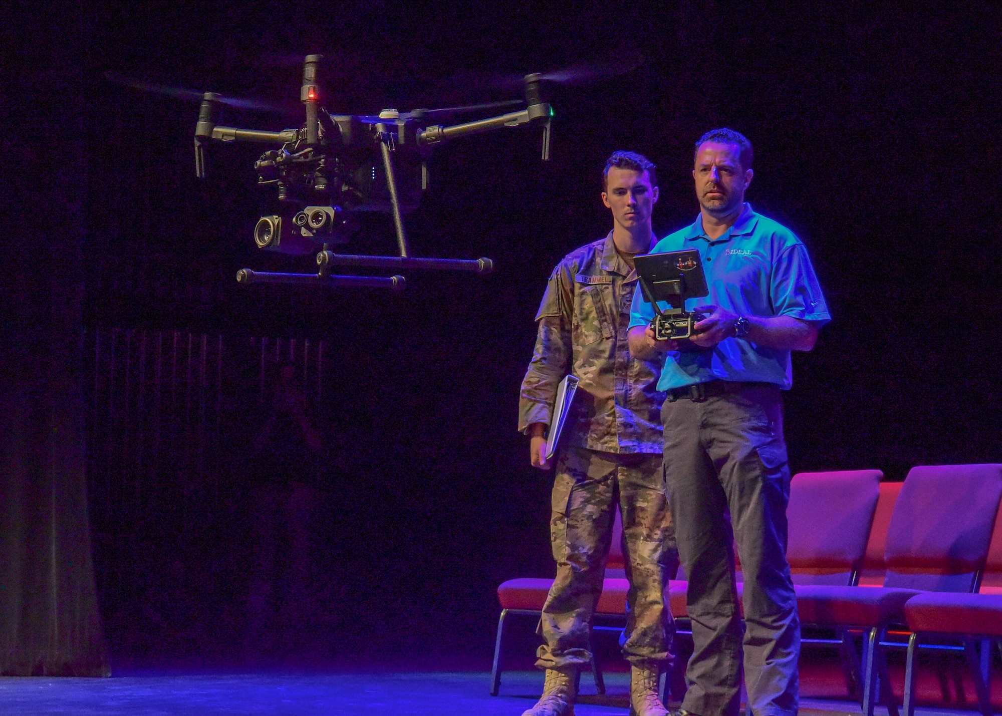 Staff Sgt. Devan Trammel, 628th Civil Engineer Squadron explosive ordnance disposal technician, observes Jeremy Stafford, Ideal Blasting vice president, as he operates a drone during a demonstration at the 2018 Eastern National Robot Rodeo Aug. 13, 2018, at the Charleston convention center in Charleston S.C.