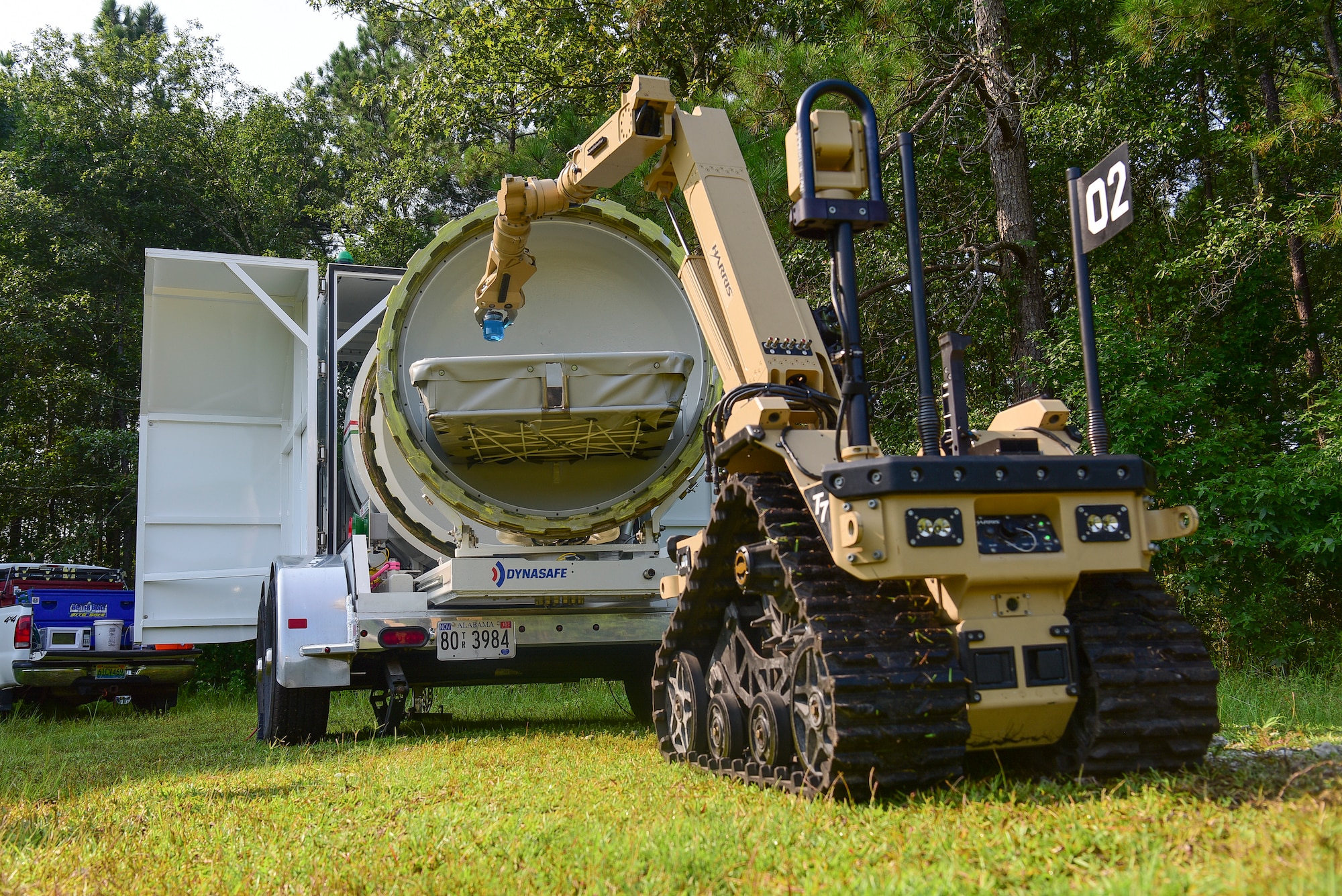 The Harris T7, a remotely operated ordnance disposal robot, places a liquid-filled vile in an explosion containment unit during the 2018 Eastern National Robotics Rodeo, Aug. 14, 2018, at Joint Base Charleston, S.C.