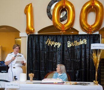 Capt. Maryann Mattonen, commanding officer of Navy Medicine Training Support Center, reads a 100th-birthday letter from Rear Adm. Tina Davidson, director, Navy Nurse Corps, and commander, Navy Medicine Education, Training and Logistics Command, to Blondina Porter, a World War II Navy nurse, at the Brookdale Assisted Living Facility. Porter was honorably discharged from the Navy in 1948, as a lieutenant.