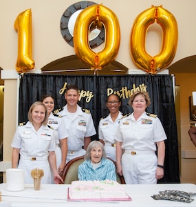 ) Navy Nurse Corps officers assigned to Navy Medicine Training Support Center and Navy Medicine Education, Training and Logistics Command, pose for a photo with Blondina Porter, a World War II Navy Nurse, at the Brookdale Assisted Living Facility.