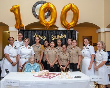 Navy Nurse Corps Officers assigned to Navy Medicine Training Support Center and Navy Medicine Education, Training and Logistics Command, and John Marshall High School Navy Junior Reserve Officers Training Corps (NJROTC) cadets pose for a photo with Blondina Porter, a World War II Navy Nurse, at the Brookdale Assisted Living Facility. Porter was honorably discharged from the Navy in 1948, as a lieutenant.