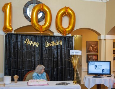 Blondina Porter, a World War II Navy Nurse, watches a video presentation showcasing a timeline of her 100-year life during her 100th birthday celebration at the San Antonio Brookdale Assisted Living Facility. Porter was honorably discharged from the Navy in 1948, as a lieutenant.