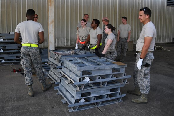 Munitions specialists assigned to the 307th Maintenance Squadron and 910th MXS train to handle, transport and store Bomb Dispenser Unit-50 low drags at the 307th MXS munitions storage facility on Barksdale Air Force Base, La., August 16, 2018. (U.S. Air Force photo by Airman 1st Class Maxwell Daigle/Released)
