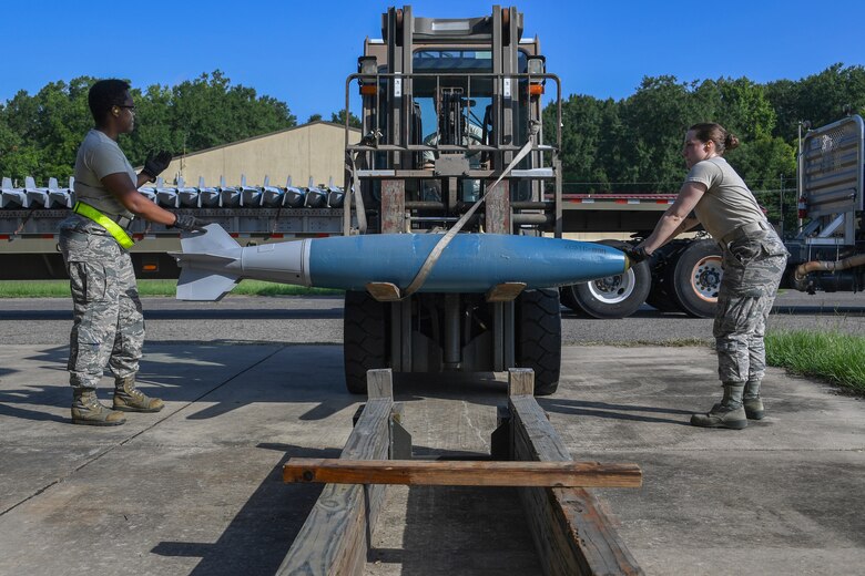Munitions specialists assigned to the 307th and 910th maintenance squadron train to assemble, handle, transport and store BDU-50 low drag bombs at the 307th MXS munitions storage facility on Barksdale Air Force Base, La., August 16, 2018. (U.S. Air Force photo by Airman 1st Class Maxwell Daigle/Released)