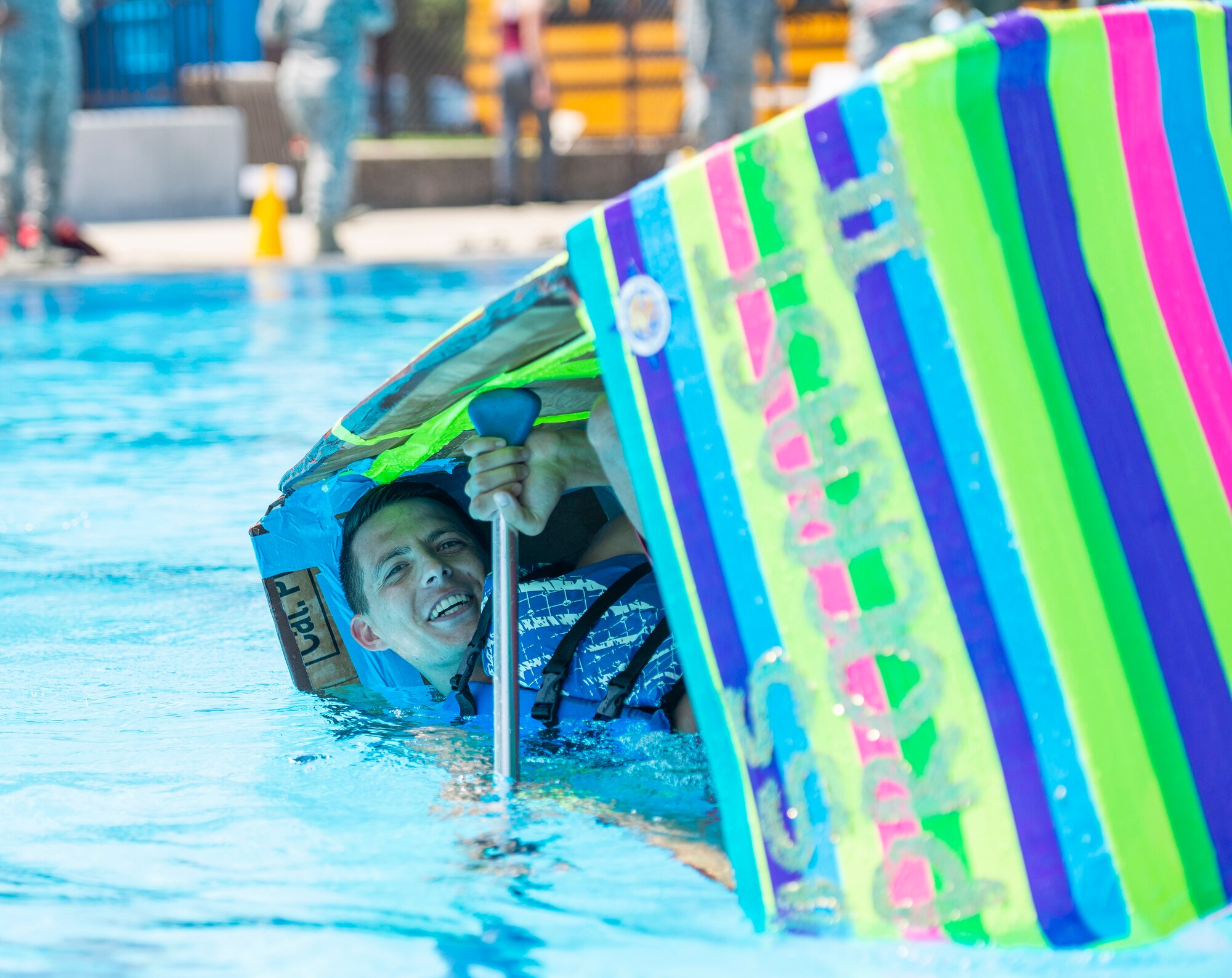 A Fitness Center Pool life guard makes his last attempt to stay afloat during the 375th Force Support Squadron Outdoor Recreation’s 11th Annual Cardboard Boat Regatta Aug. 10 at Scott Air Force Base, Illinois.