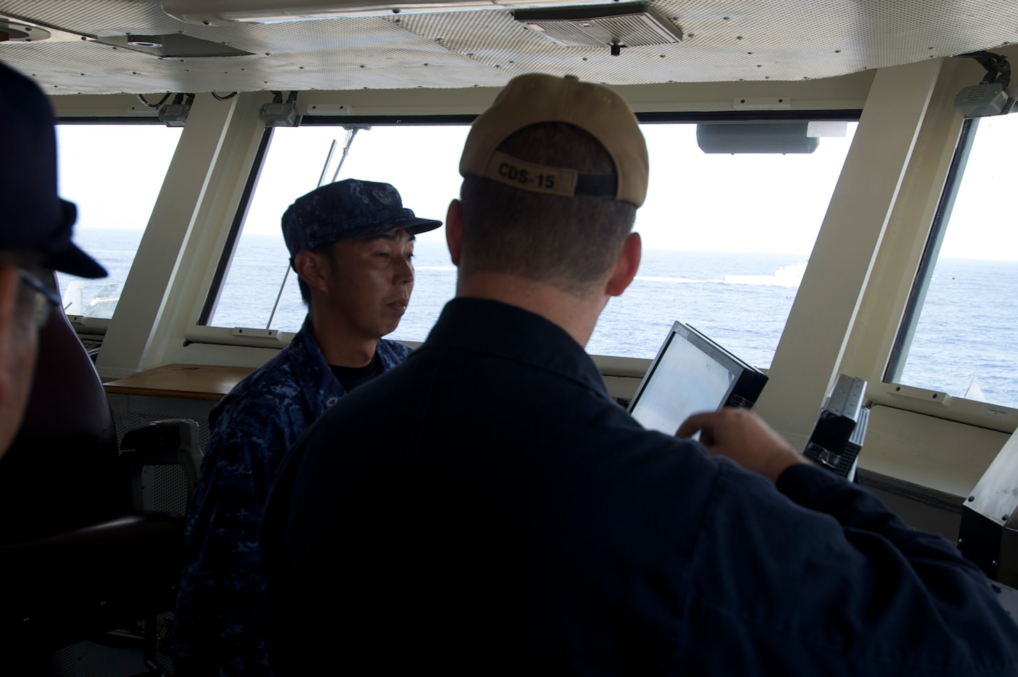 PHILIPPINE SEA (Aug. 15, 2018) Lt. Jeff Kryski, Destroyer Squadron (DESRON) 15’s assistant planning officer, explains flight operations to Japan Maritime Self-Defense Force sailors aboard the aircraft carrier USS Ronald Reagan (CVN 76). Ronald Reagan is forward-deployed to the U.S. 7th Fleet area of operations in support of security and stability in the Indo-Pacific region.