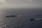 PHILIPPINE SEA (Aug. 15, 2018) The Kongo-class guided-missile destroyer JS Kirishima (DDG 174), right, sails alongside the aircraft carrier USS Ronald Reagan (CVN 76) during photo exercise. Ronald Reagan is forward-deployed to the U.S. 7th Fleet area of operations.