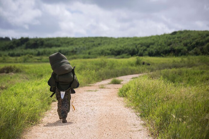 Cpl. Daniel Mehaffey carries his gear to the rendezvous point after parachuting 10,000 feet during parachute training operations Aug. 13, 2018 at Ie Shima, Okinawa, Japan. Landing Support Company completed parachute and air delivery training to ensure Marines maintain proficiency and meet required training hours. Mehaffey, a parachute rigger with Air Delivery Platoon, LS Co., 3rd Transportation Support Battalion, is a native of Warminster, Pennsylvania. (U.S. Marine Corps photo by Lance Cpl. Jamin M. Powell)