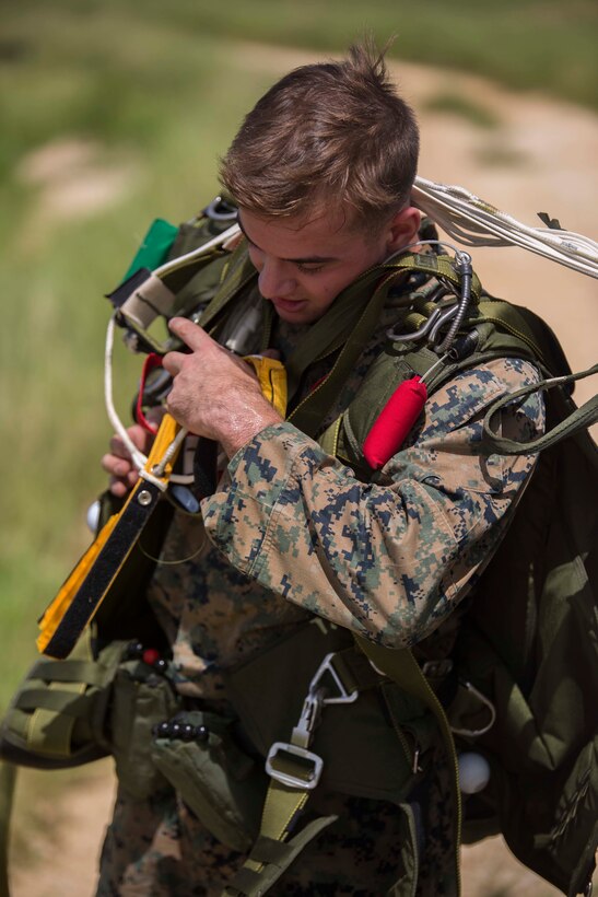 Cpl. Daniel Mehaffey removes his gear after jumping out of a CH-53E Super Stallion during parachute training operations Aug. 13, 2018 at Ie Shima, Okinawa, Japan. Landing Support Company completed parachute and air delivery training to ensure Marines maintain proficiency and meet required training hours. Mehaffey, a parachute rigger with Air Delivery Platoon, LS Co., 3rd Transportation Support Battalion, is a native of Warminster, Pennsylvania. (U.S. Marine Corps photo by Lance Cpl. Jamin M. Powell)