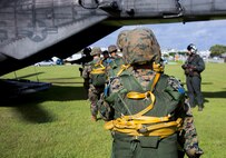 Marines with Landing Support Company, 3rd Transportation Support Battalion, 3rd Marine Logistics Group, board a CH-53E Super Stallion helicopter during parachute and air delivery training operations Aug. 14, 2018 at Ie Shima, Okinawa, Japan. The training consisted of low-level static line and military free fall jumps at 10,000 feet in order to keep the Marines proficient as parachute rigger/air delivery specialists. (U.S. Marine Corps photo by Cpl. Isabella Ortega)