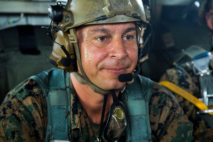 Master Sgt. Gabriel Machado prepares for takeoff during parachute and air delivery training operations Aug. 14, 2018 at Ie Shima, Okinawa, Japan. Machado served as the assistant jumpmaster during the training, keeping in contact with the flight crew inside a CH-53E Super Stallion helicopter while relaying information to the jumpmaster. The training consisted of low-level static line and military free fall jumps at 10,000 feet in order to keep the Marines proficient as parachute rigger/air delivery specialists. Machado, a native of New York, New York, is the air delivery chief with Landing Support Company, 3rd Transportation Support Battalion, 3rd Marine Logistics Group. (U.S. Marine Corps photo by Cpl. Isabella Ortega)
