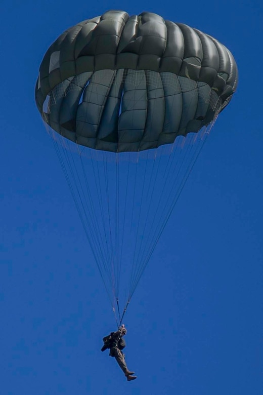 Lance Cpl. Daniel Vollman parachutes to the ground after jumping from a CH-53E Super Stallion during parachute training operations Aug. 13, 2018 at Ie Shima, Okinawa, Japan. Landing Support Company completed parachute and air delivery training to ensure Marines maintain proficiency and meet required training hours. Vollman, a parachute rigger with Air Delivery Platoon, LS Co., 3rd Transportation Support Battalion, is a native of Alexandria, Louisiana. (U.S. Marine Corps photo by Lance Cpl. Jamin M. Powell)
