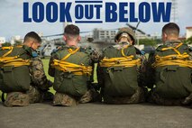 Marines with Landing Support Company, 3rd Transportation Support Battalion, 3rd Marine Logistics Group, wait next to the Camp Foster parade deck to board a CH-53E Super Stallion helicopter during parachute and air delivery training operations Aug. 14, 2018 at Ie Shima, Okinawa, Japan. The training consisted of low-level static line and military free fall jumps at 10,000 feet in order to keep the Marines proficient as parachute rigger/air delivery specialists. (U.S. Marine Corps photo by Cpl. Isabella Ortega)