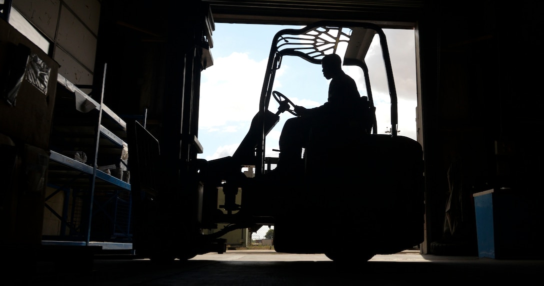 U.S. Air Force Senior Airman Barnell Thomas, 100th Logistics Readiness Squadron aircraft parts store journeyman, unloads a new shipment of supplies in the warehouse at RAF Mildenhall, England, Aug. 8, 2018. The aircraft parts store provides aircraft with mobility readiness spare part kits. The kits are air-transportable packages of spare parts configured for rapid deployment in support of conflict or war. (U.S. Air Force photo by Airman 1st Class Alexandria Lee)