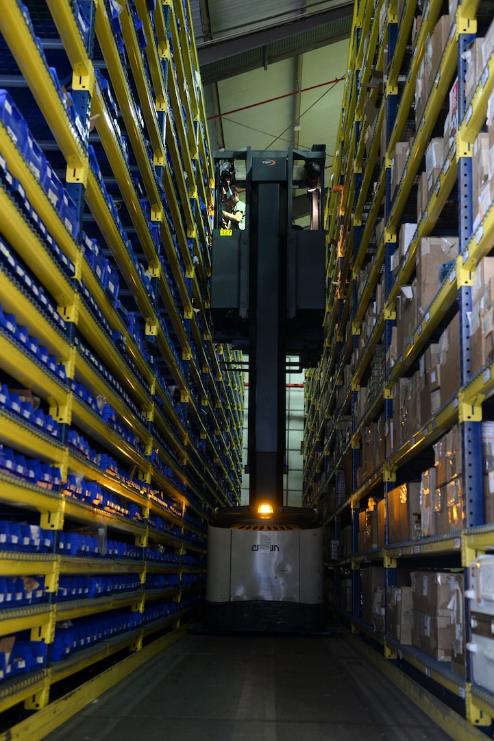 U.S Air Force Airman Patrick Fitzgerald, 100th Logistics Readiness Squadron aircraft parts store apprentice, grabs a requested aircraft part from the APS warehouse at RAF Mildenhall, England, Aug. 8, 2018. The aircraft parts store's main purpose is to provide flightline support to the aircraft maintenance crews 24-hours a day, seven-days-a-week. (U.S. Air Force photo by Airman 1st Class Alexandria Lee)